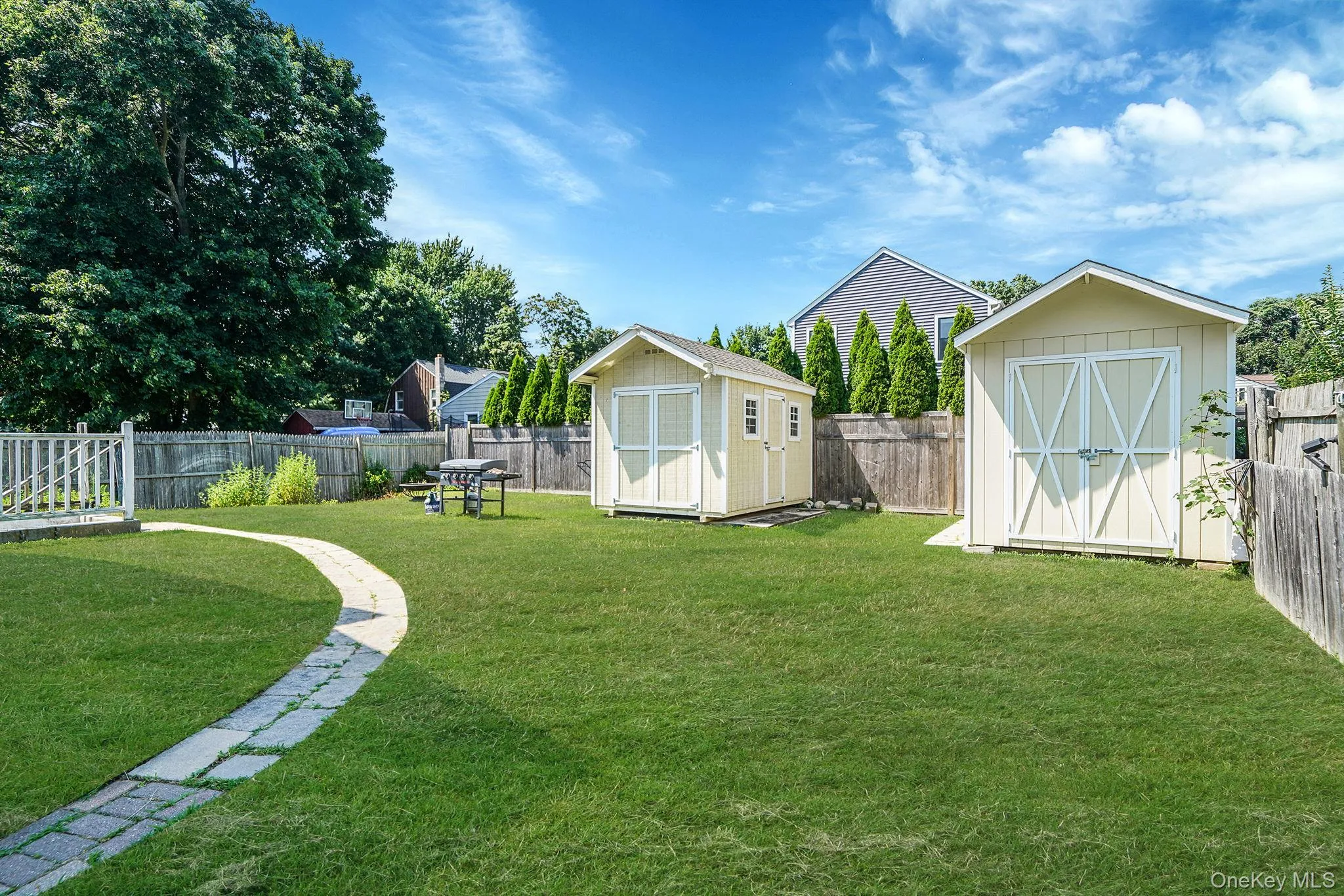Fenced backyard with a storage shed Fenced backyard with a storage shed