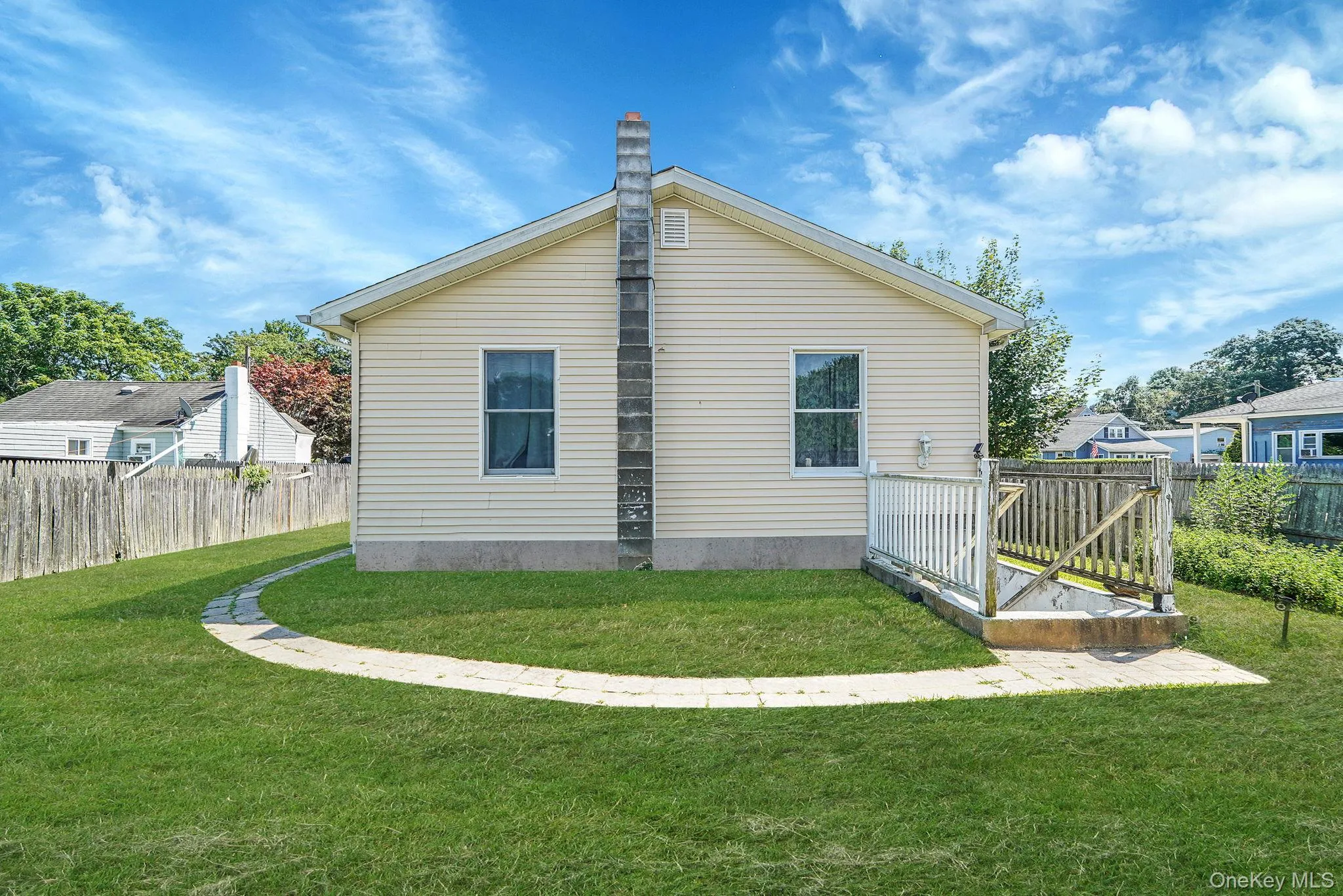 View of home's exterior featuring a chimney View of home's exterior featuring a chimney