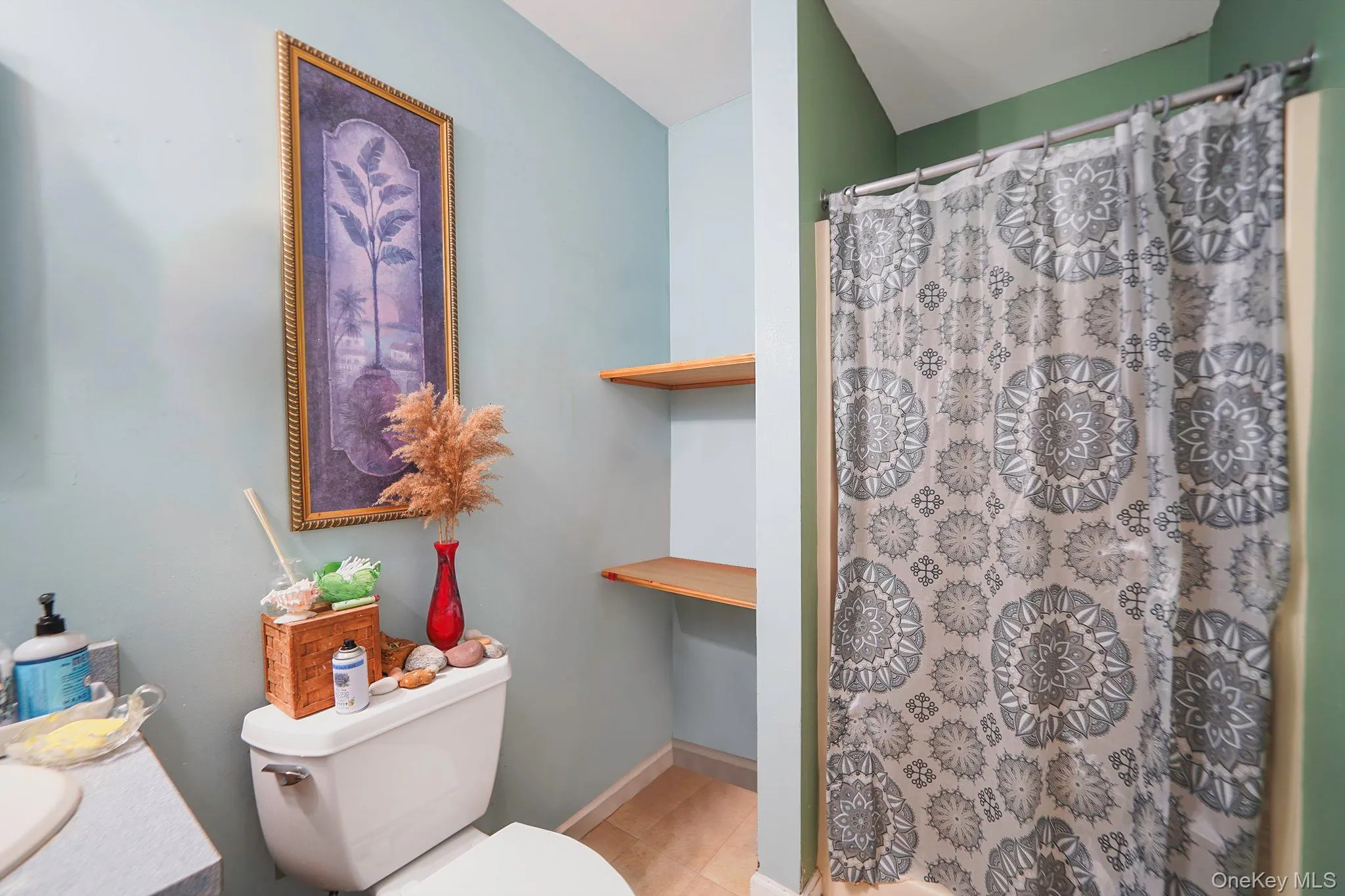 Primary Full bath featuring vanity, curtained shower, and tile patterned floors Primary Full bath featuring vanity, curtained shower, and tile patterned floors