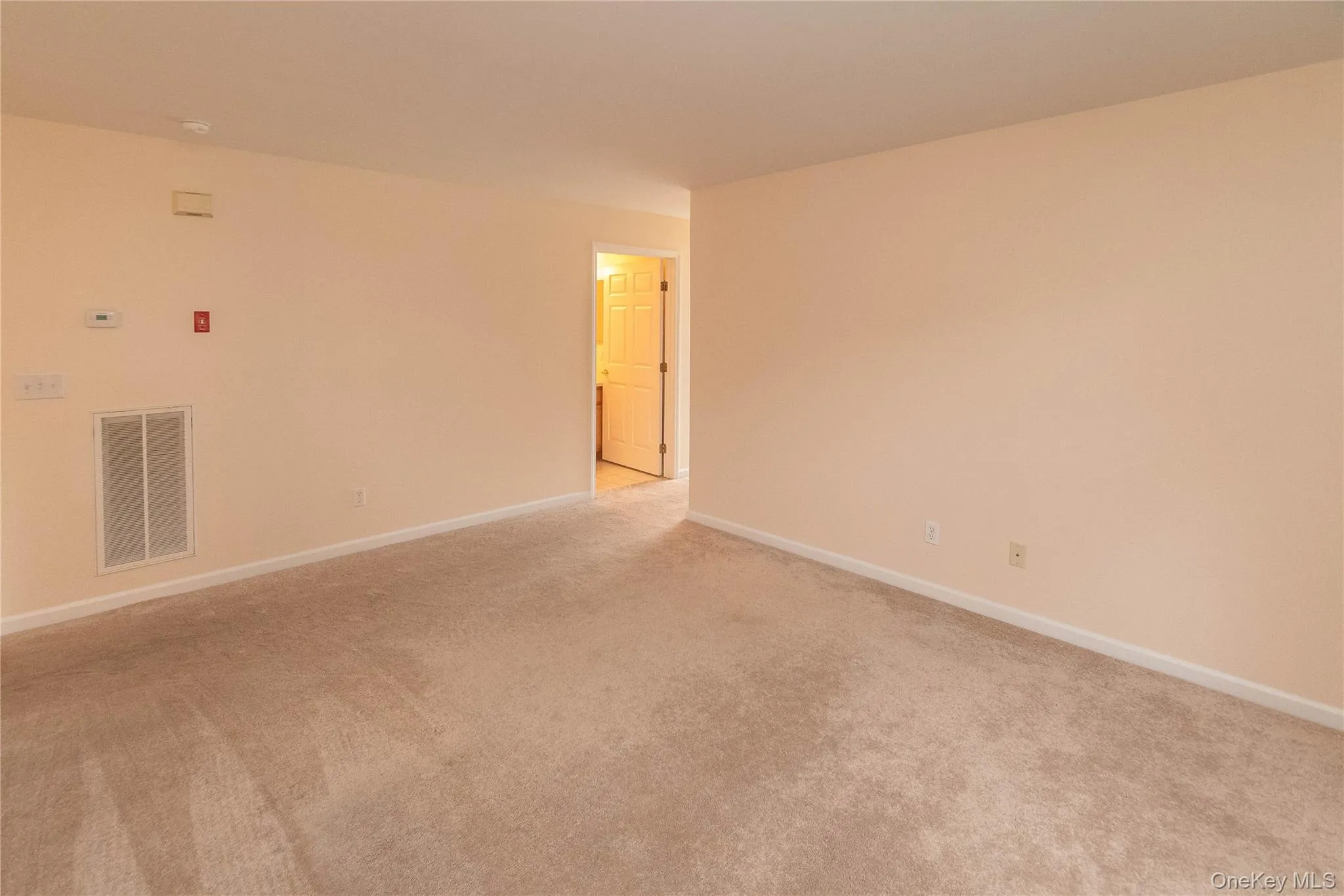 Unfurnished room with baseboards and light colored carpet Unfurnished room with baseboards and light colored carpet