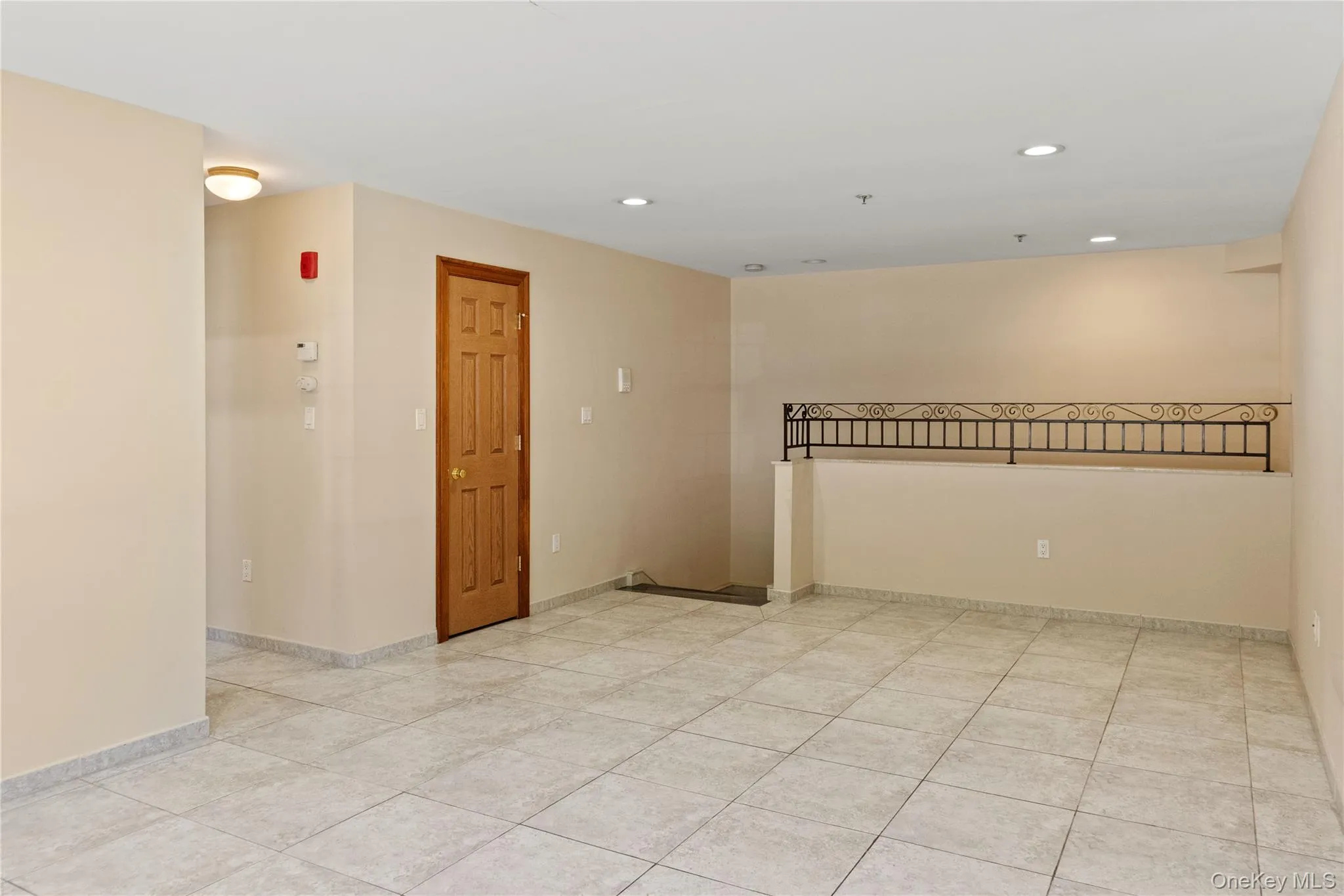 Empty room with recessed lighting and light tile patterned floors Empty room with recessed lighting and light tile patterned floors