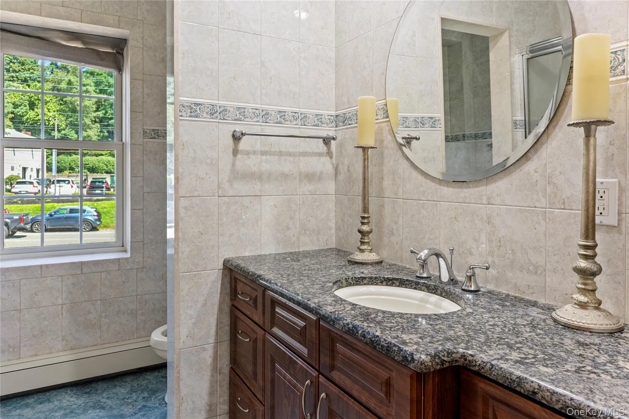 Bathroom featuring tile walls, a baseboard heating unit, and vanity Bathroom featuring tile walls, a baseboard heating unit, and vanity