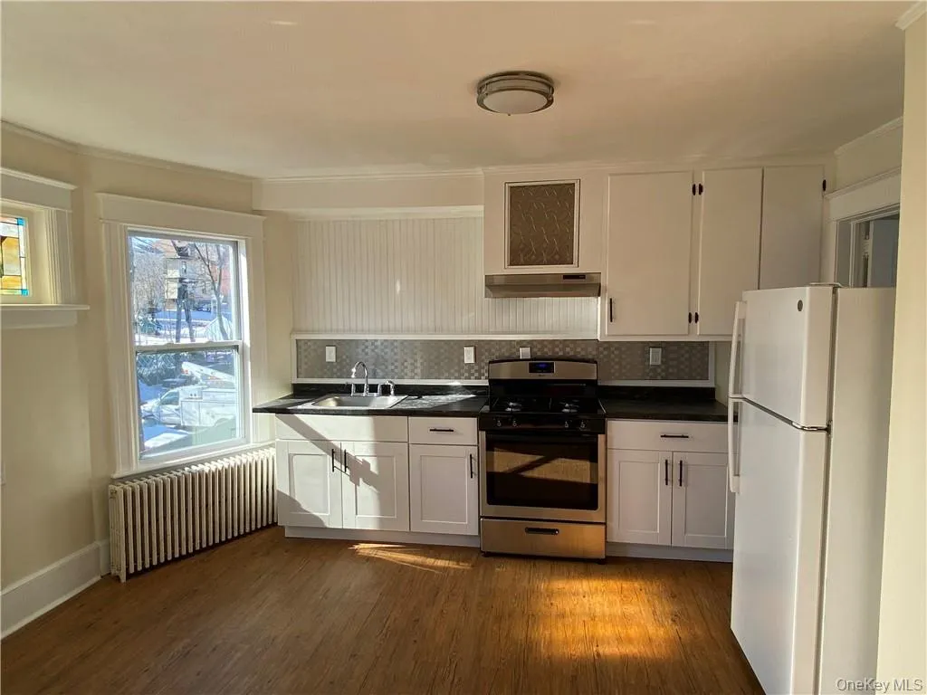 Renovated kitchen with upgraded plumbing, electric, and new stainless steel oven/range and backsplash Renovated kitchen with upgraded plumbing, electric, and new stainless steel oven/range and backsplash