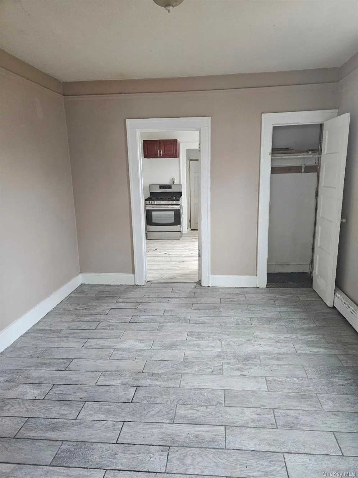 Unfurnished bedroom featuring wood tiled floors and a closet Unfurnished bedroom featuring wood tiled floors and a closet