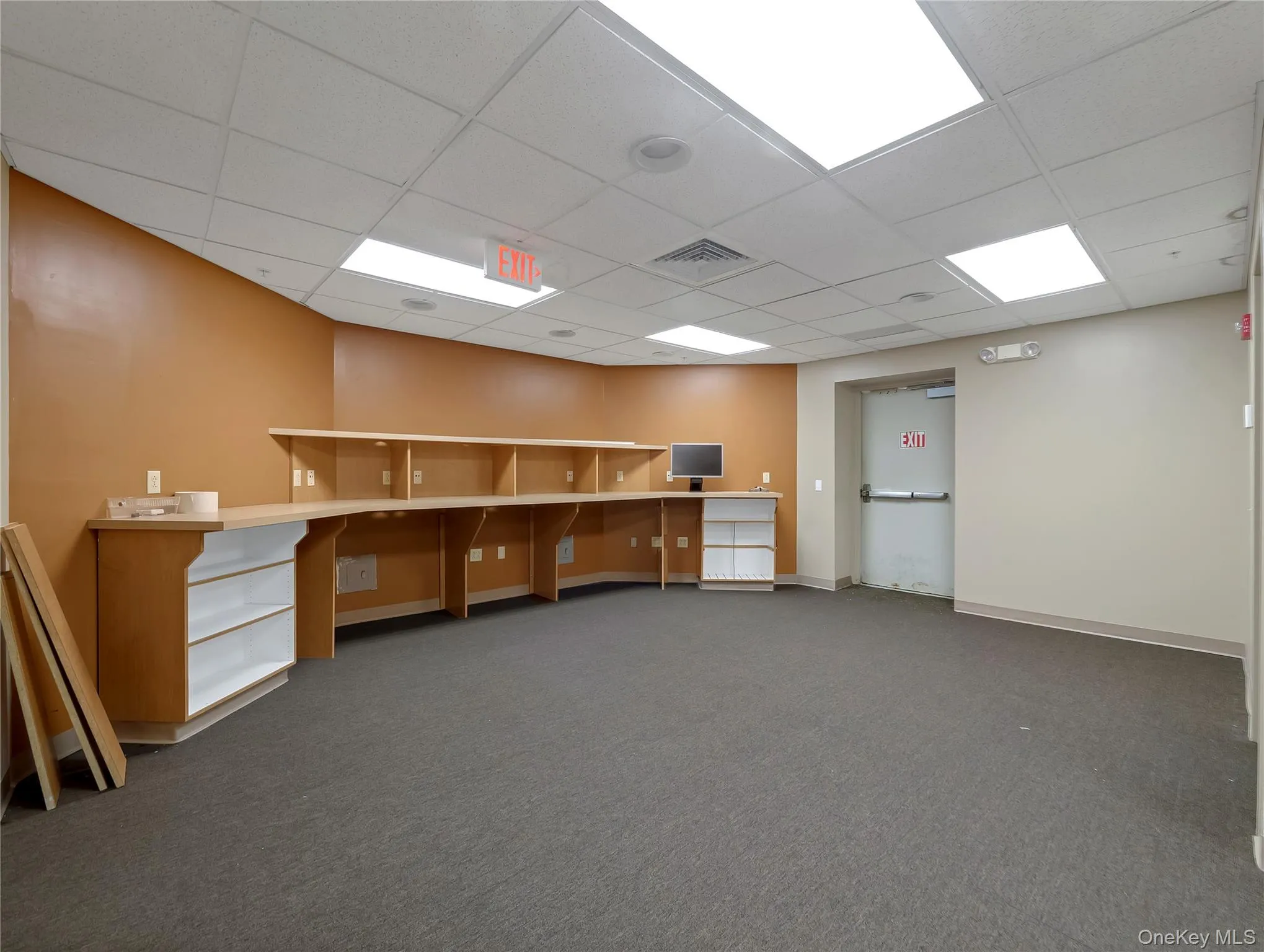 Empty room featuring carpet flooring and a paneled ceiling Empty room featuring carpet flooring and a paneled ceiling