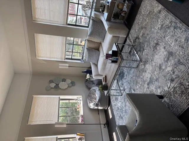 Living room featuring carpet flooring and baseboards Living room featuring carpet flooring and baseboards