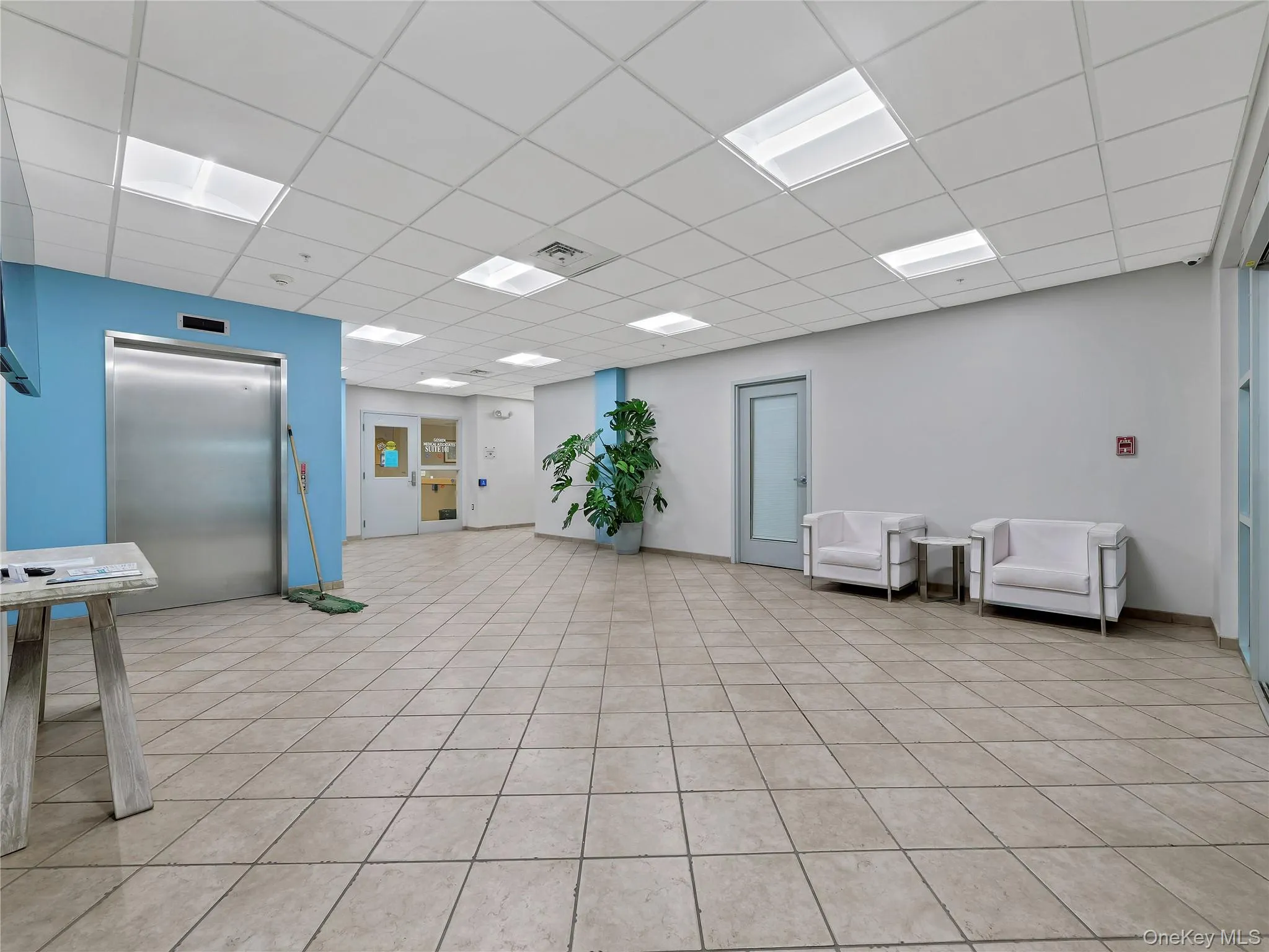 Community lobby featuring a drop ceiling Community lobby featuring a drop ceiling