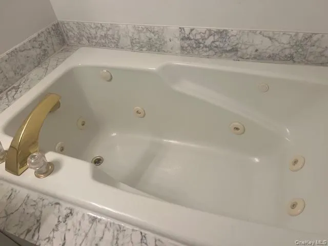 Bathroom view of a tub with jets Bathroom view of a tub with jets