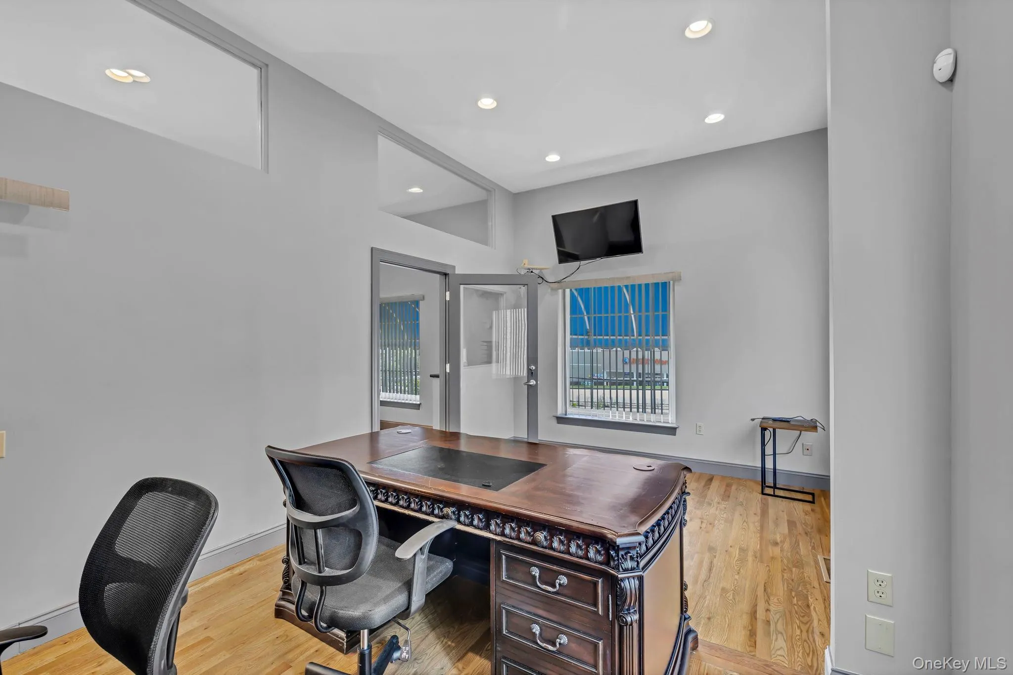 Home office with wood finished floors, recessed lighting, and baseboards Home office with wood finished floors, recessed lighting, and baseboards