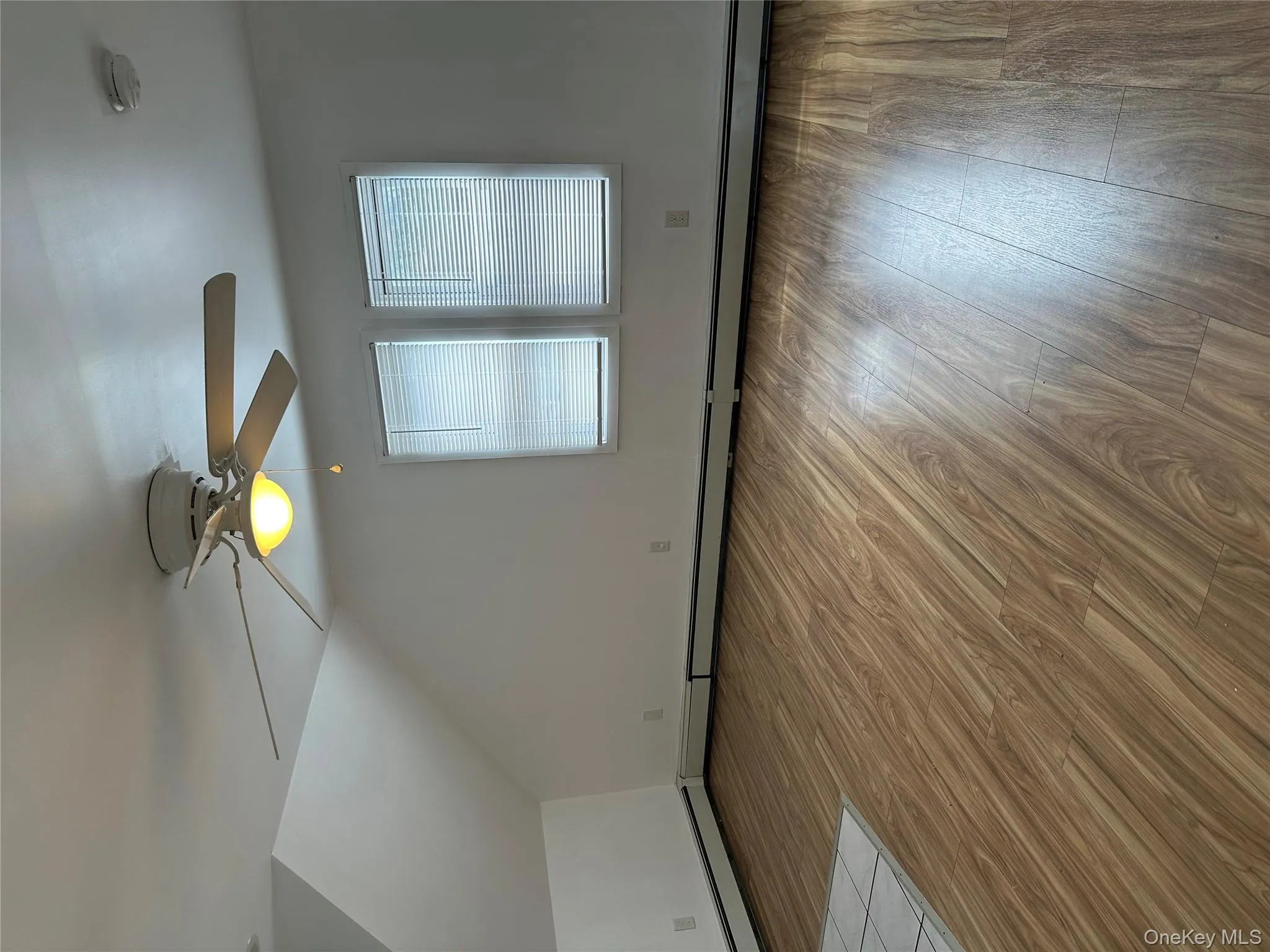 Additional living space featuring light wood-type flooring, a baseboard radiator, lofted ceiling, and ceiling fan Additional living space featuring light wood-type flooring, a baseboard radiator, lofted ceiling, and ceiling fan