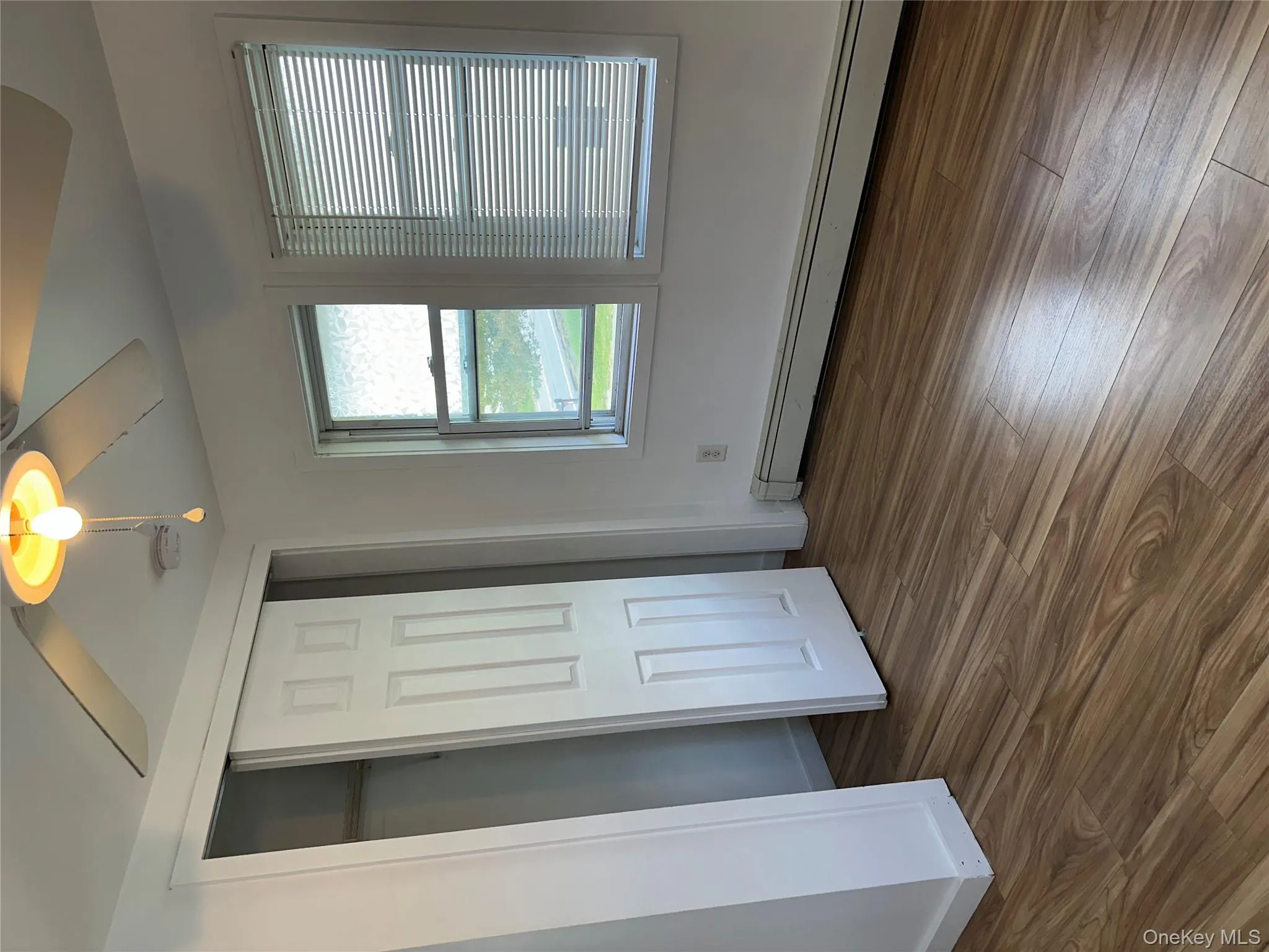 Unfurnished bedroom featuring baseboard heating, dark wood finished floors, ceiling fan, and a closet Unfurnished bedroom featuring baseboard heating, dark wood finished floors, ceiling fan, and a closet