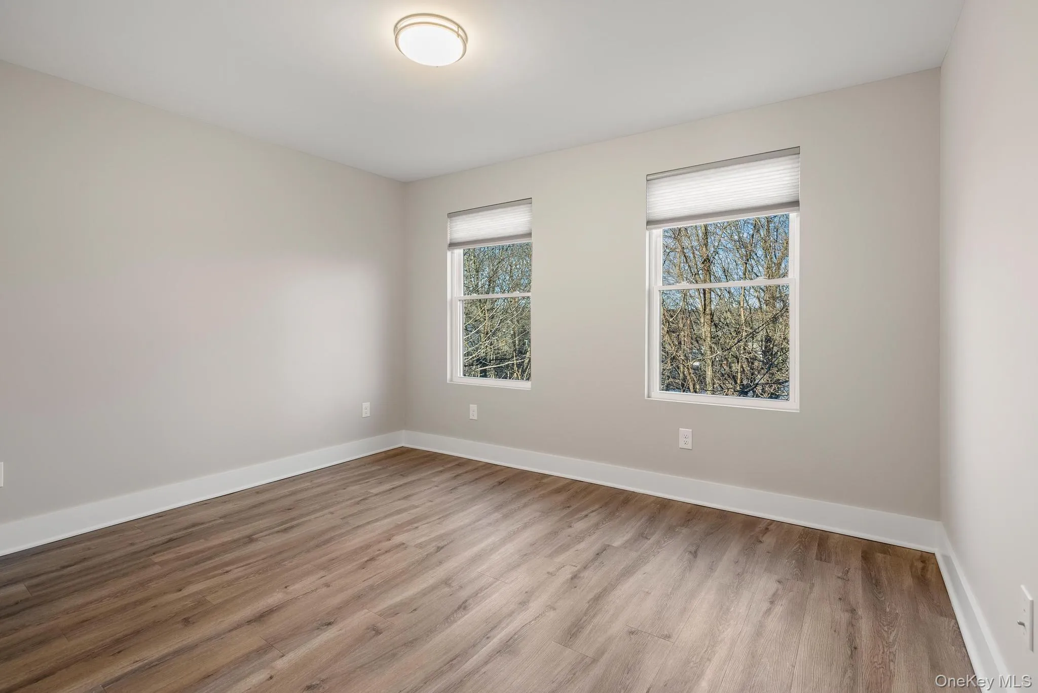 Unfurnished room featuring baseboards and wood finished floors Unfurnished room featuring baseboards and wood finished floors