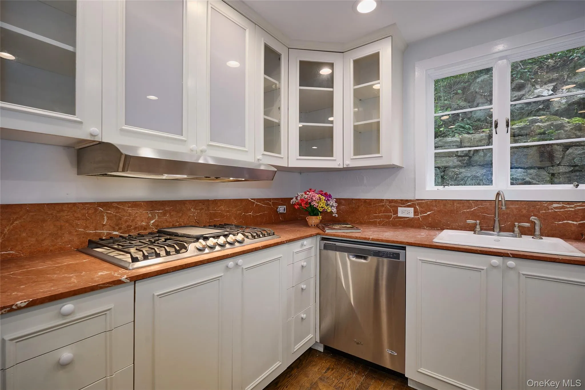 Kitchen with white cabinetry, stainless steel appliances, glass insert cabinets, and recessed lighting Kitchen with white cabinetry, stainless steel appliances, glass insert cabinets, and recessed lighting
