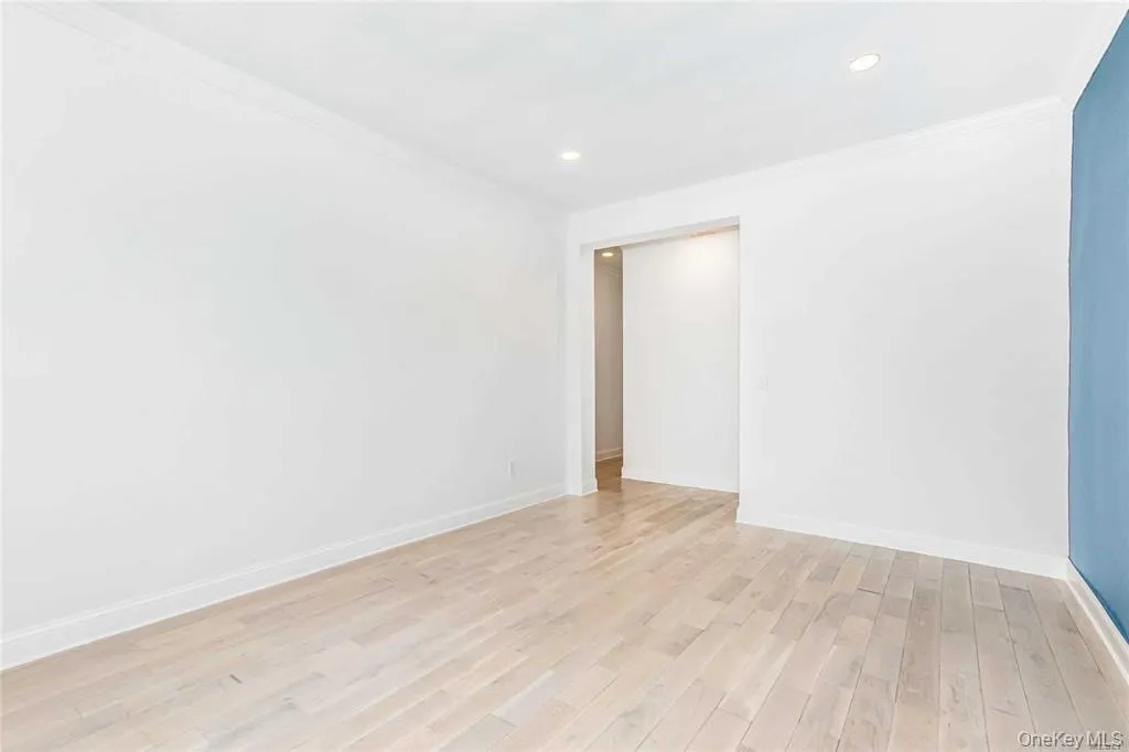 Unfurnished room with ornamental molding, light wood finished floors, and recessed lighting Unfurnished room with ornamental molding, light wood finished floors, and recessed lighting