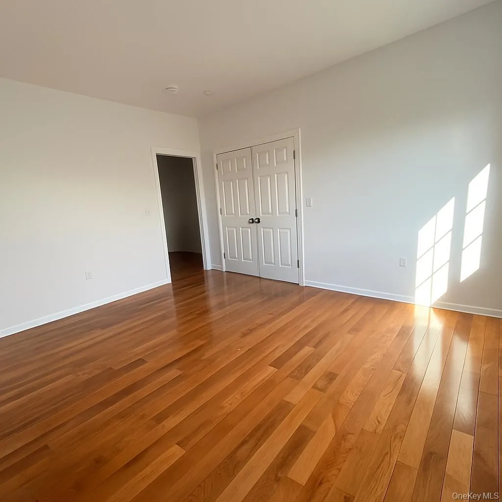 Unfurnished bedroom with light wood finished floors and a closet Unfurnished bedroom with light wood finished floors and a closet