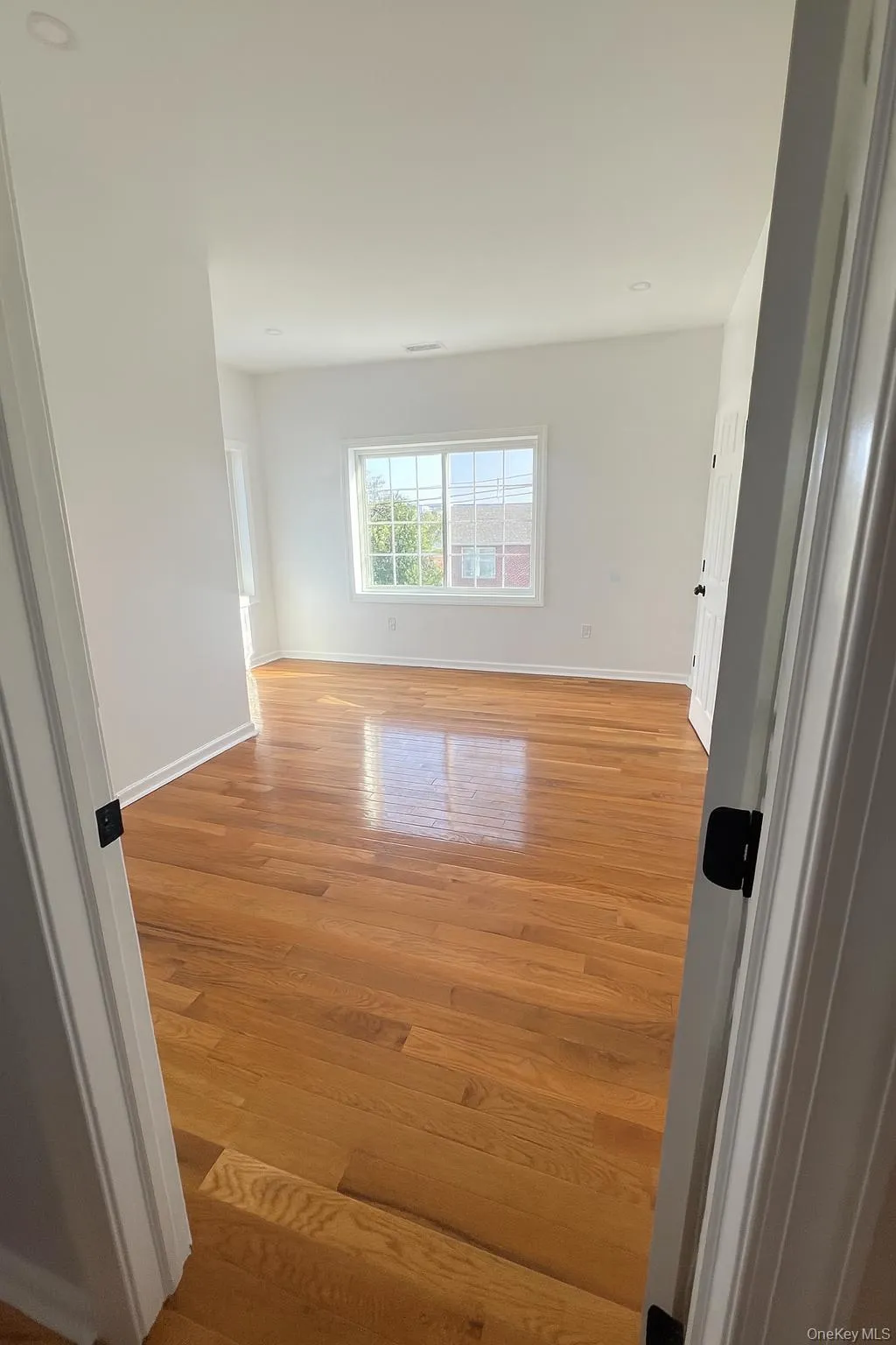 Empty room featuring light wood-type flooring and baseboards Empty room featuring light wood-type flooring and baseboards