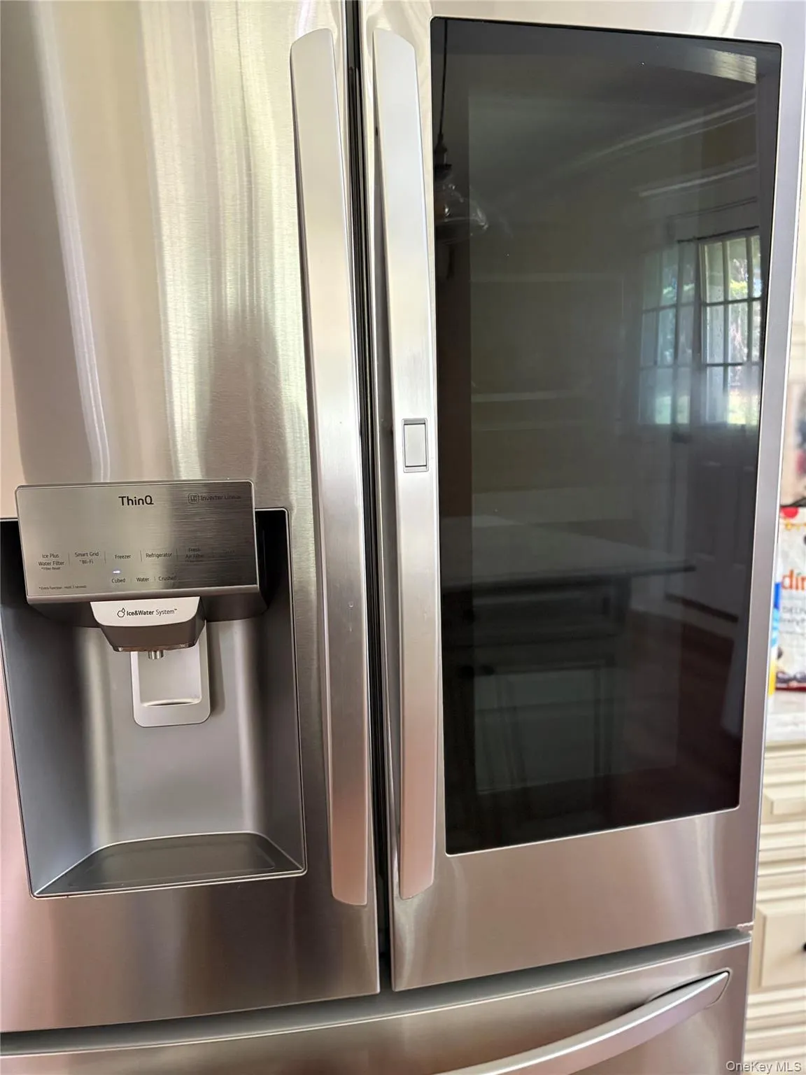 Kitchen view of stainless steel fridge with ice dispenser Kitchen view of stainless steel fridge with ice dispenser
