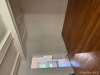 Unfurnished room with dark wood-style floors, beam ceiling, and crown molding Unfurnished room with dark wood-style floors, beam ceiling, and crown molding