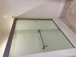 Full bathroom with bath / shower combo with glass door and baseboards Full bathroom with bath / shower combo with glass door and baseboards