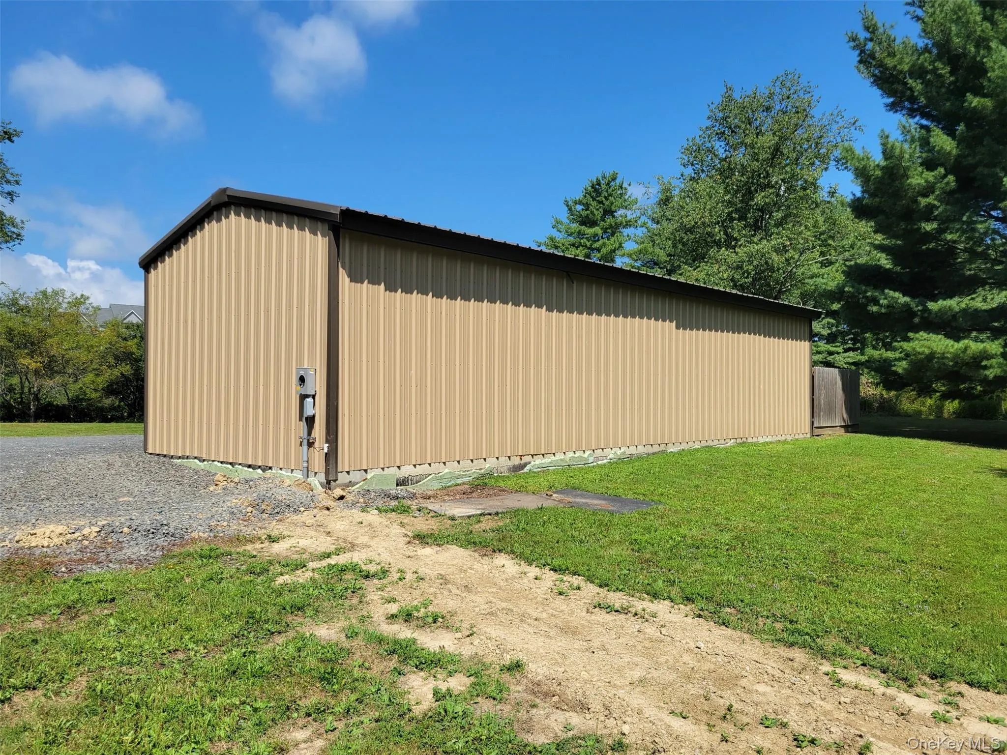 View of pole building featuring a yard View of pole building featuring a yard