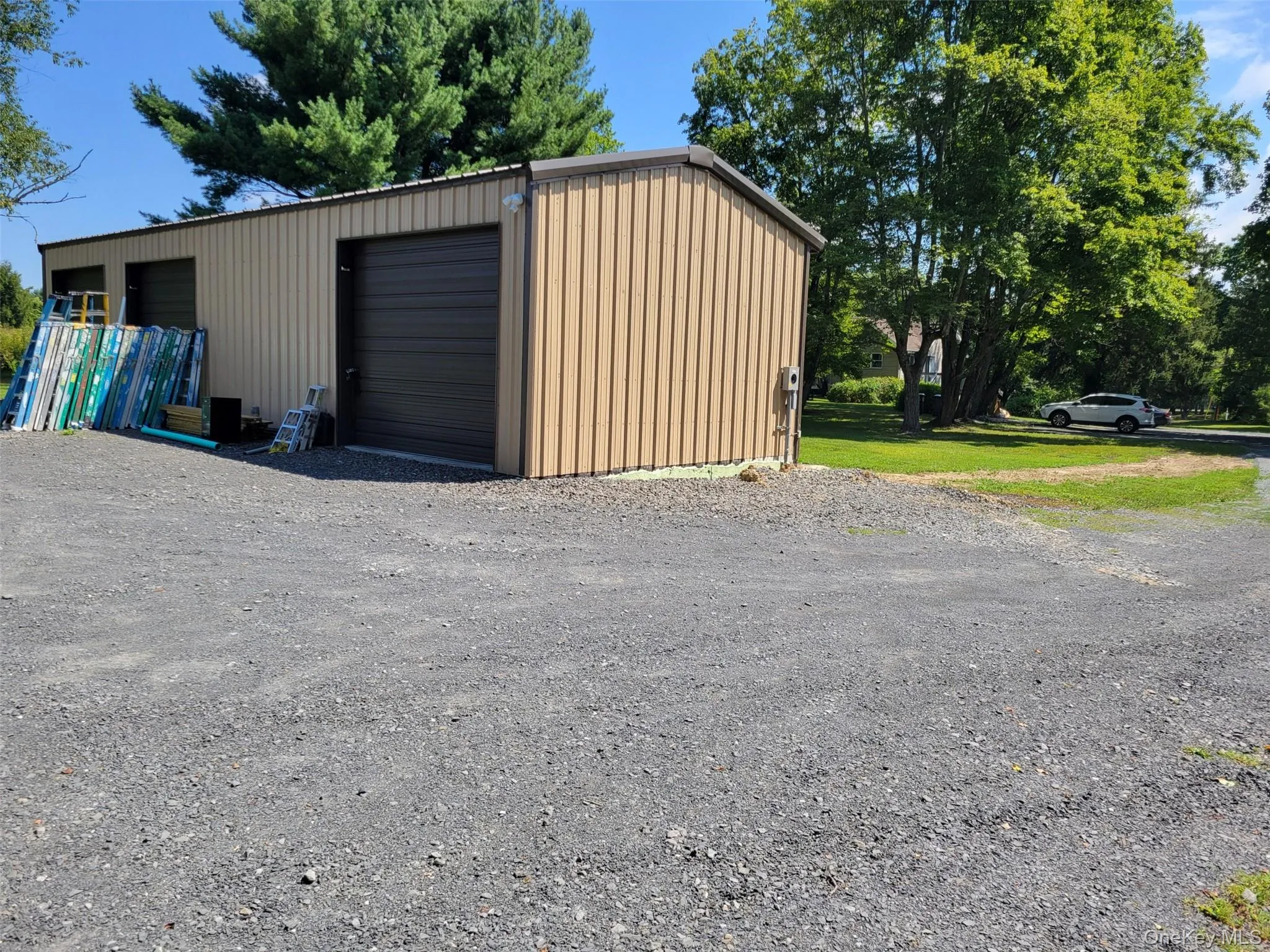 Detached garage featuring gravel driveway Detached garage featuring gravel driveway