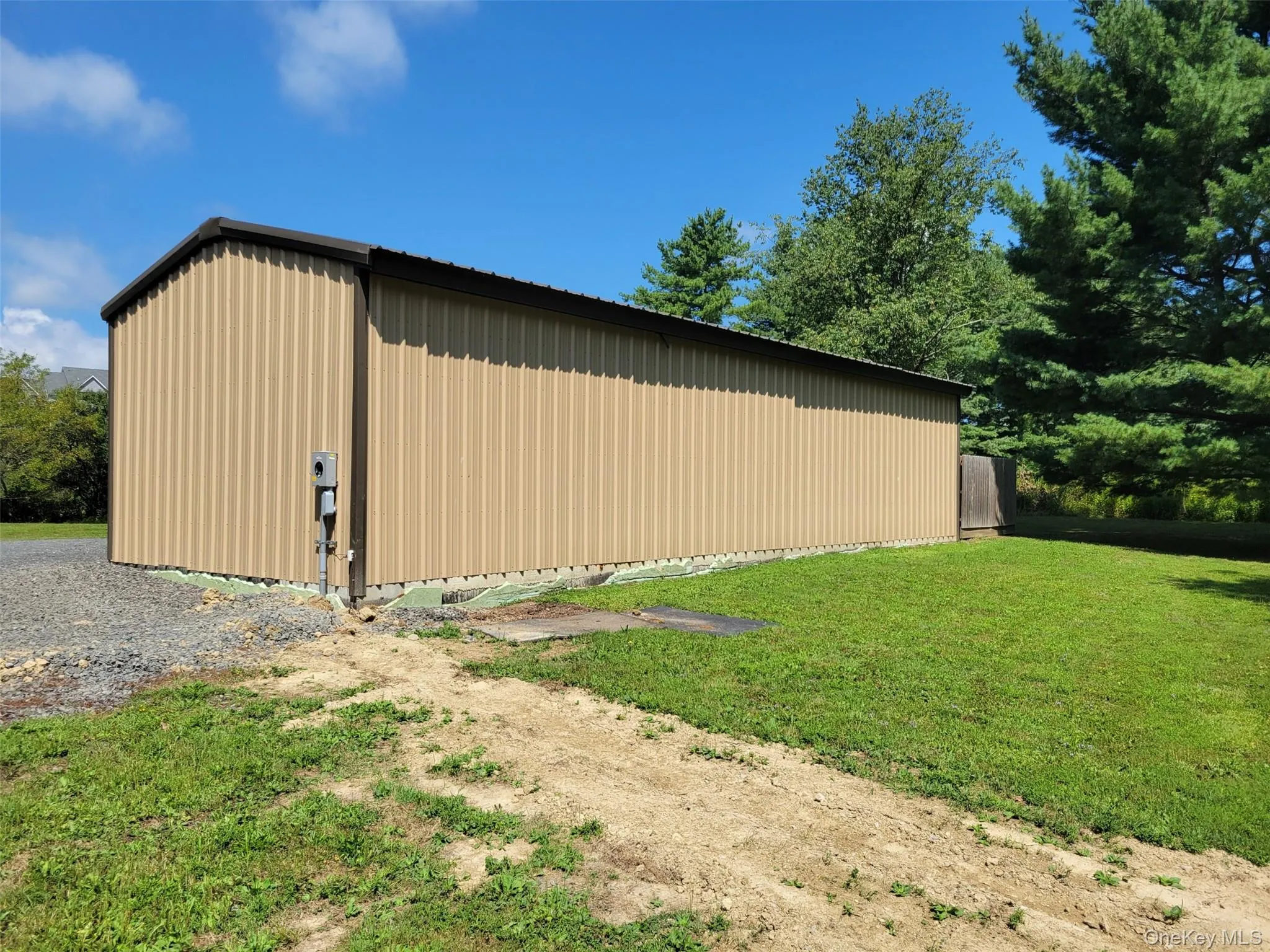 View of pole building with a lawn View of pole building with a lawn