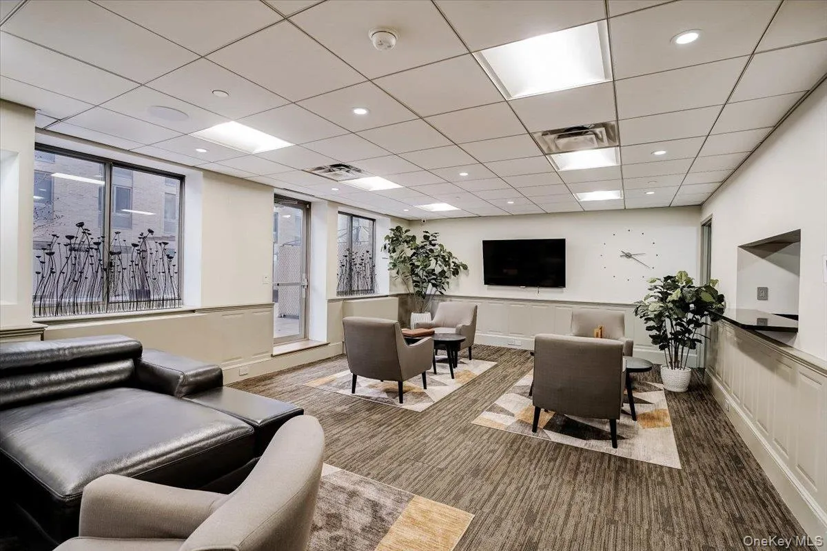 Building lobby with a paneled ceiling and recessed lighting Building lobby with a paneled ceiling and recessed lighting