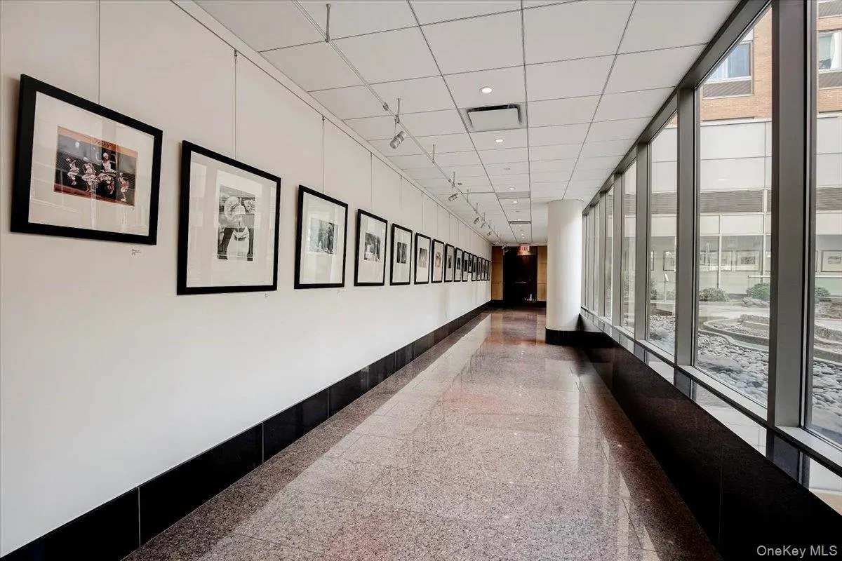 Hallway with baseboards and expansive windows Hallway with baseboards and expansive windows