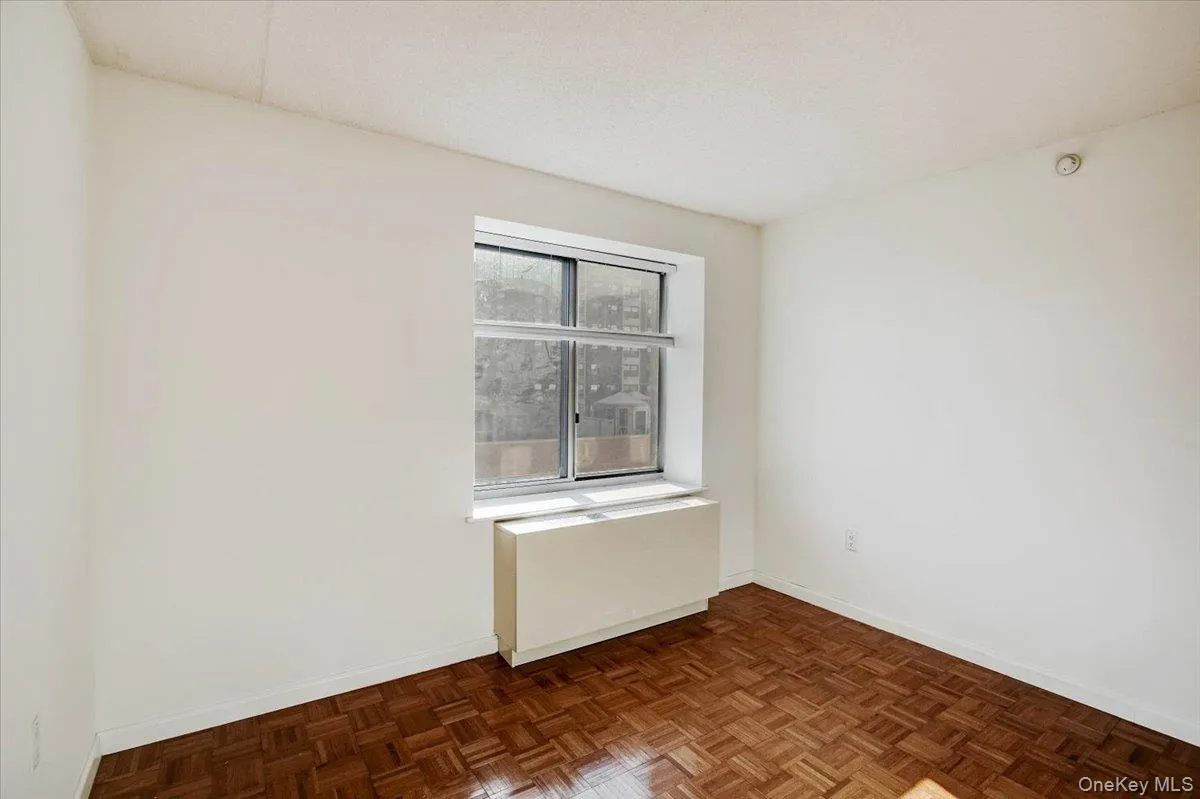 Spare room with radiator and baseboards Spare room with radiator and baseboards