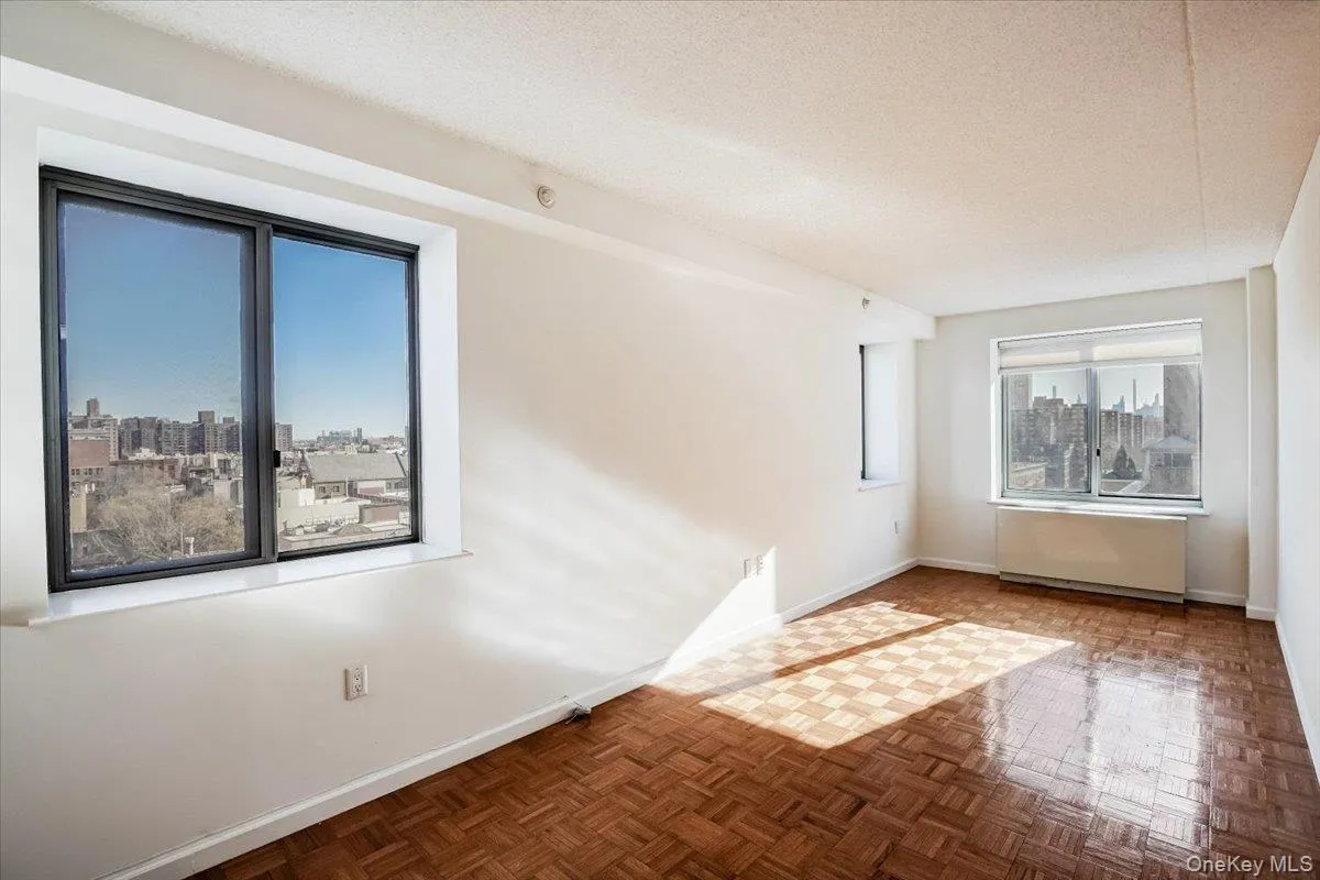 Spare room with a skyline view, a textured ceiling, and radiator Spare room with a skyline view, a textured ceiling, and radiator