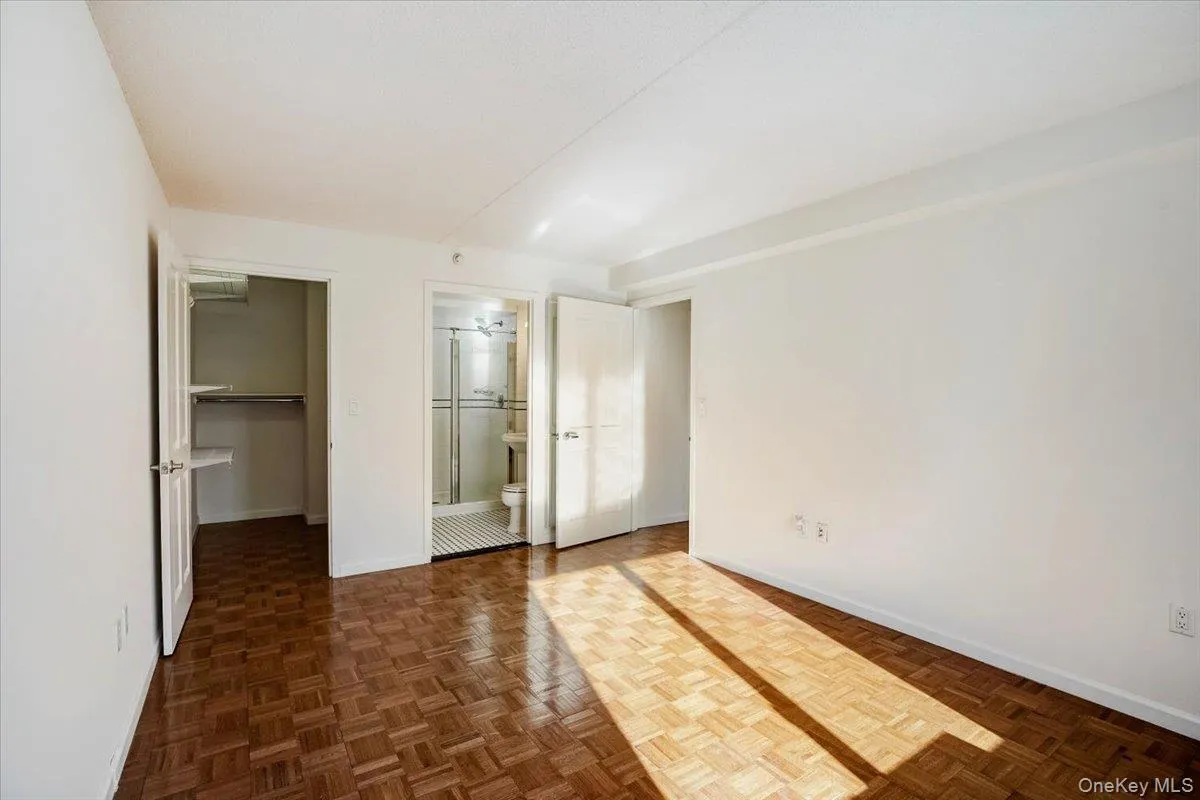 Unfurnished bedroom with a walk in closet and ensuite bathroom Unfurnished bedroom with a walk in closet and ensuite bathroom