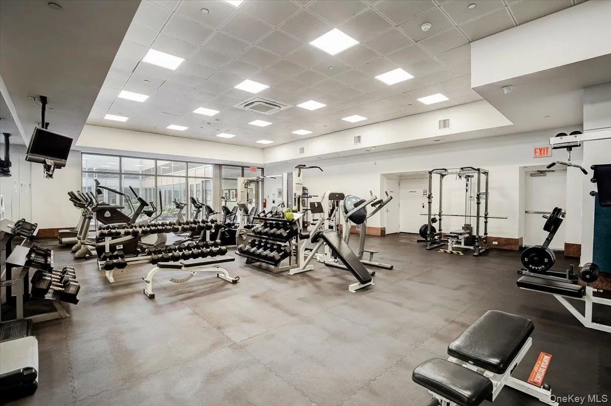 Workout area featuring a paneled ceiling and baseboards Workout area featuring a paneled ceiling and baseboards