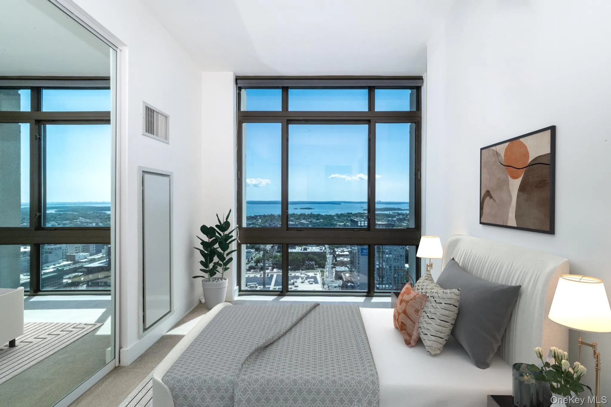 Bedroom with floor to ceiling windows and a water view Bedroom with floor to ceiling windows and a water view