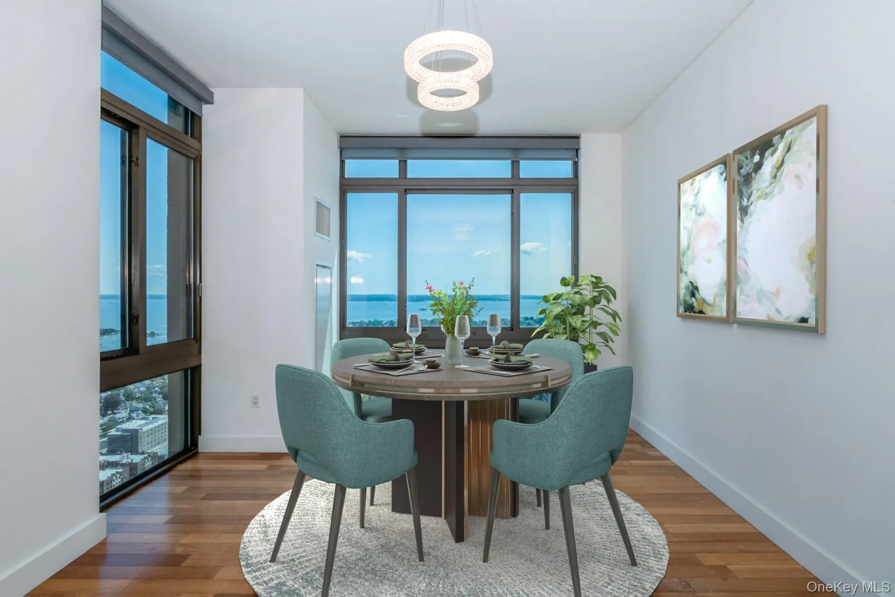 Dining area featuring healthy amount of natural light, a water view, and wood finished floors. Virtually staged photo Dining area featuring healthy amount of natural light, a water view, and wood finished floors. Virtually staged photo