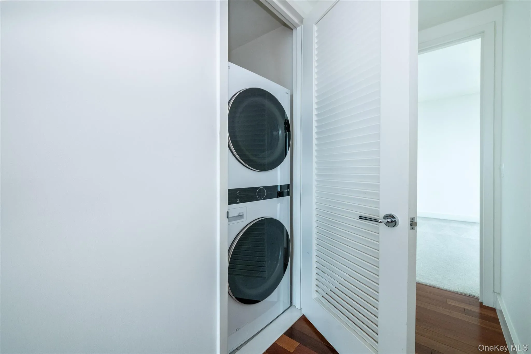 Washroom featuring stacked washer / dryer Washroom featuring stacked washer / dryer