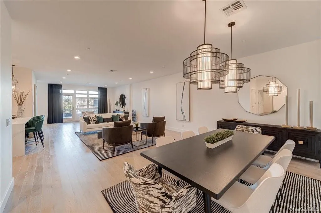 Dining area featuring a chandelier, light wood-style floors, and recessed lighting Dining area featuring a chandelier, light wood-style floors, and recessed lighting