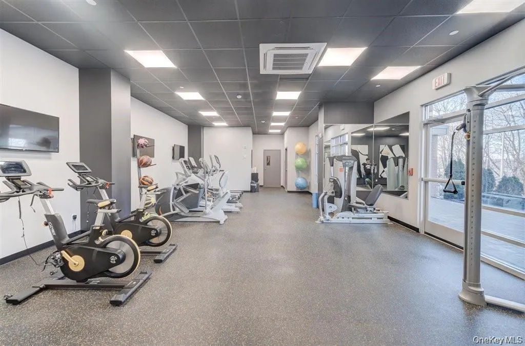 Exercise room with a drop ceiling and cooling unit Exercise room with a drop ceiling and cooling unit