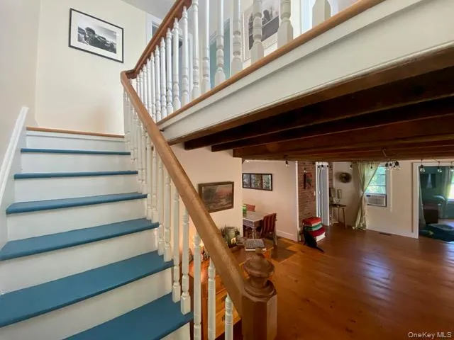 Stairway featuring wood finished floors and baseboards Stairway featuring wood finished floors and baseboards
