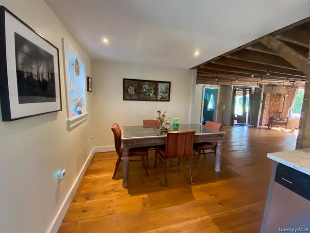 Dining room featuring light wood-type flooring, beamed ceiling, and recessed lighting Dining room featuring light wood-type flooring, beamed ceiling, and recessed lighting
