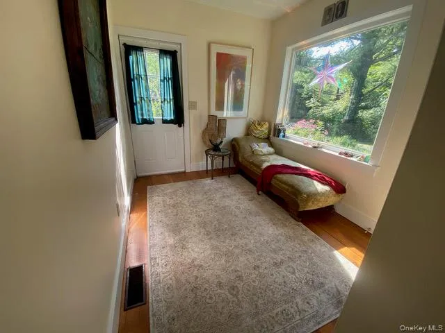 Entryway featuring wood finished floors and baseboards Entryway featuring wood finished floors and baseboards
