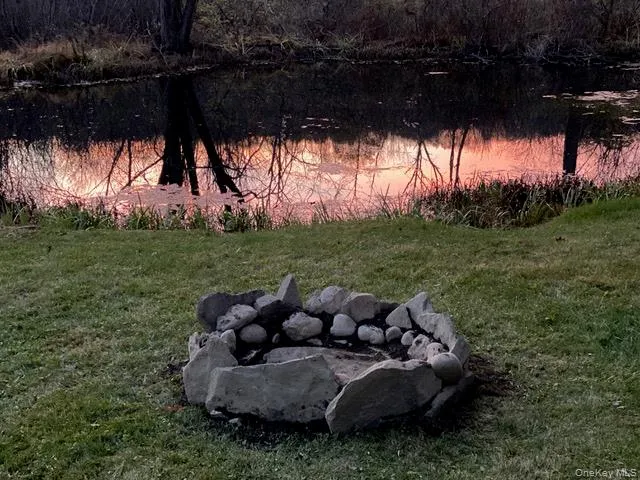 View of grassy yard featuring a water view View of grassy yard featuring a water view