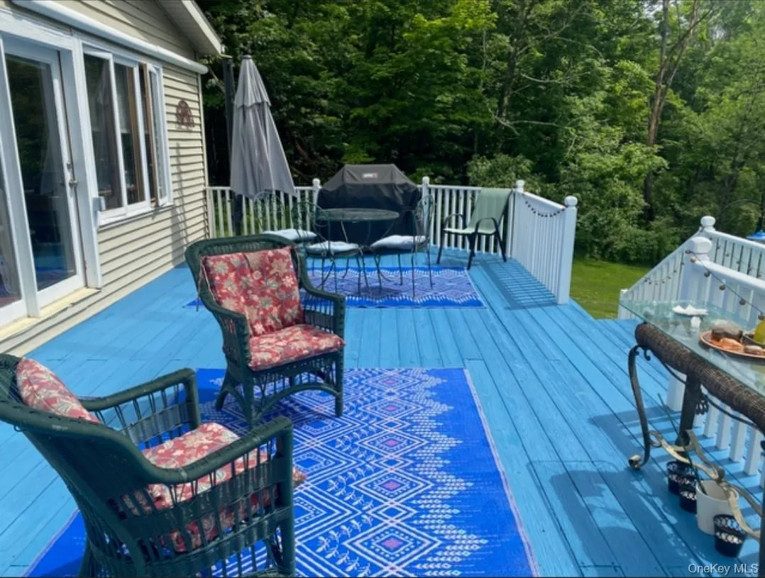 Wooden deck featuring grilling area Wooden deck featuring grilling area