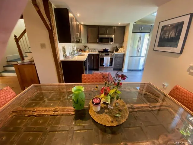 Kitchen with appliances with stainless steel finishes, decorative backsplash, and dark brown cabinetry Kitchen with appliances with stainless steel finishes, decorative backsplash, and dark brown cabinetry