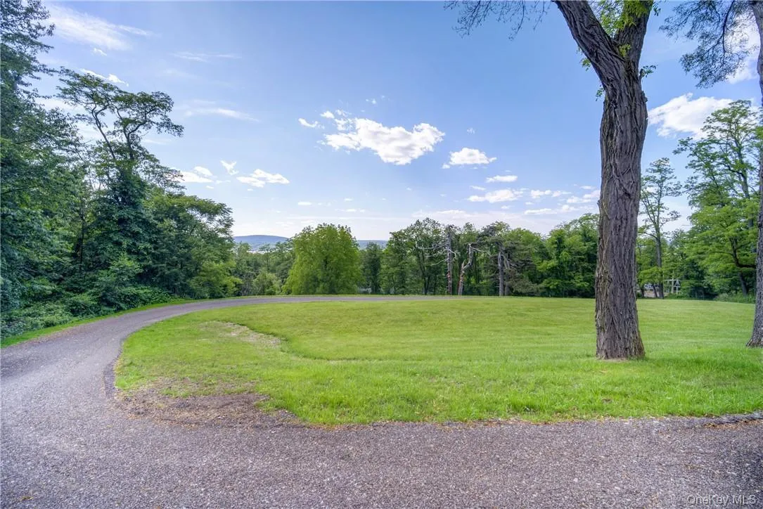 View of property\'s community featuring a lawn View of property\'s community featuring a lawn