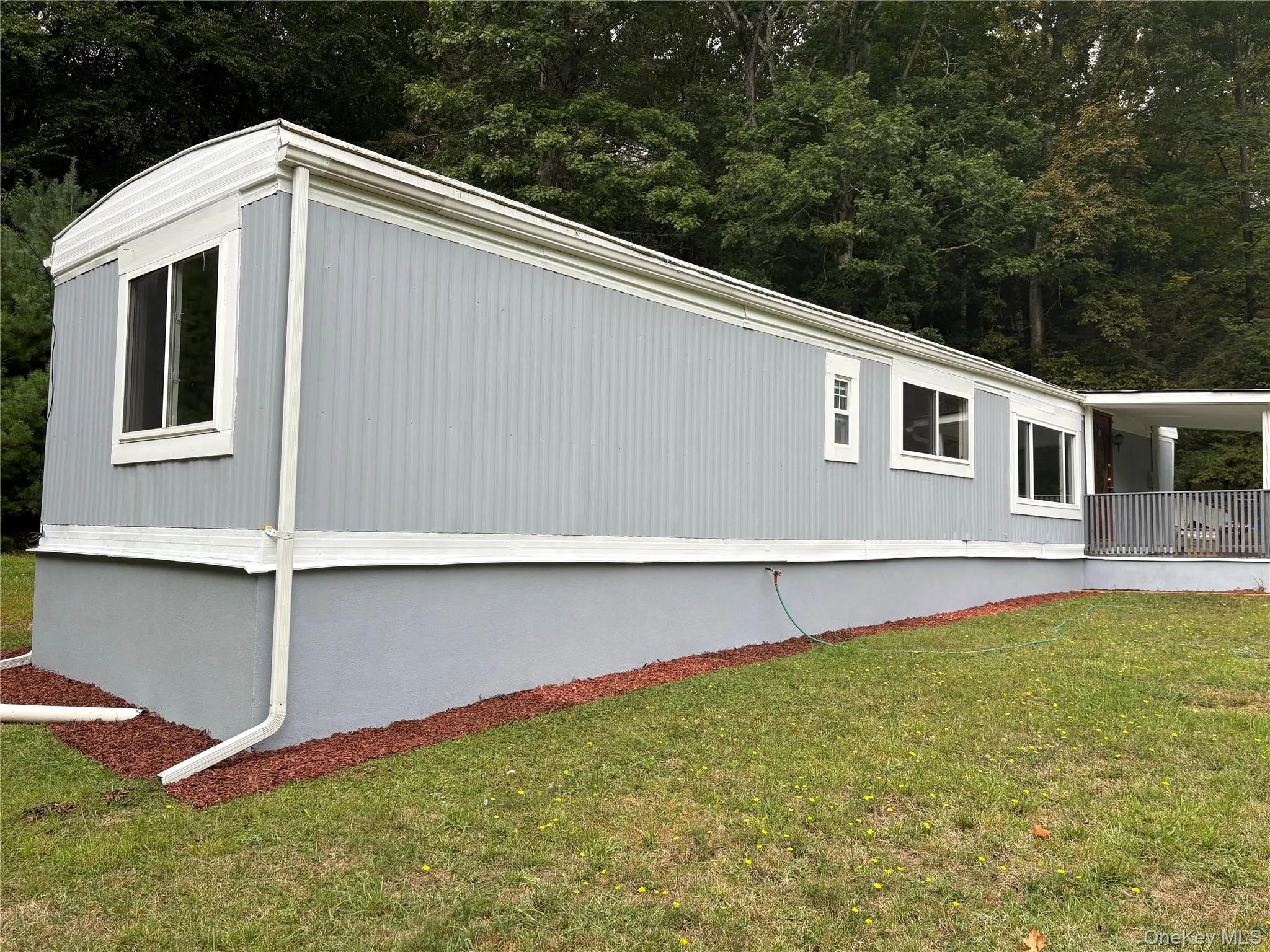 View of property exterior featuring a yard View of property exterior featuring a yard