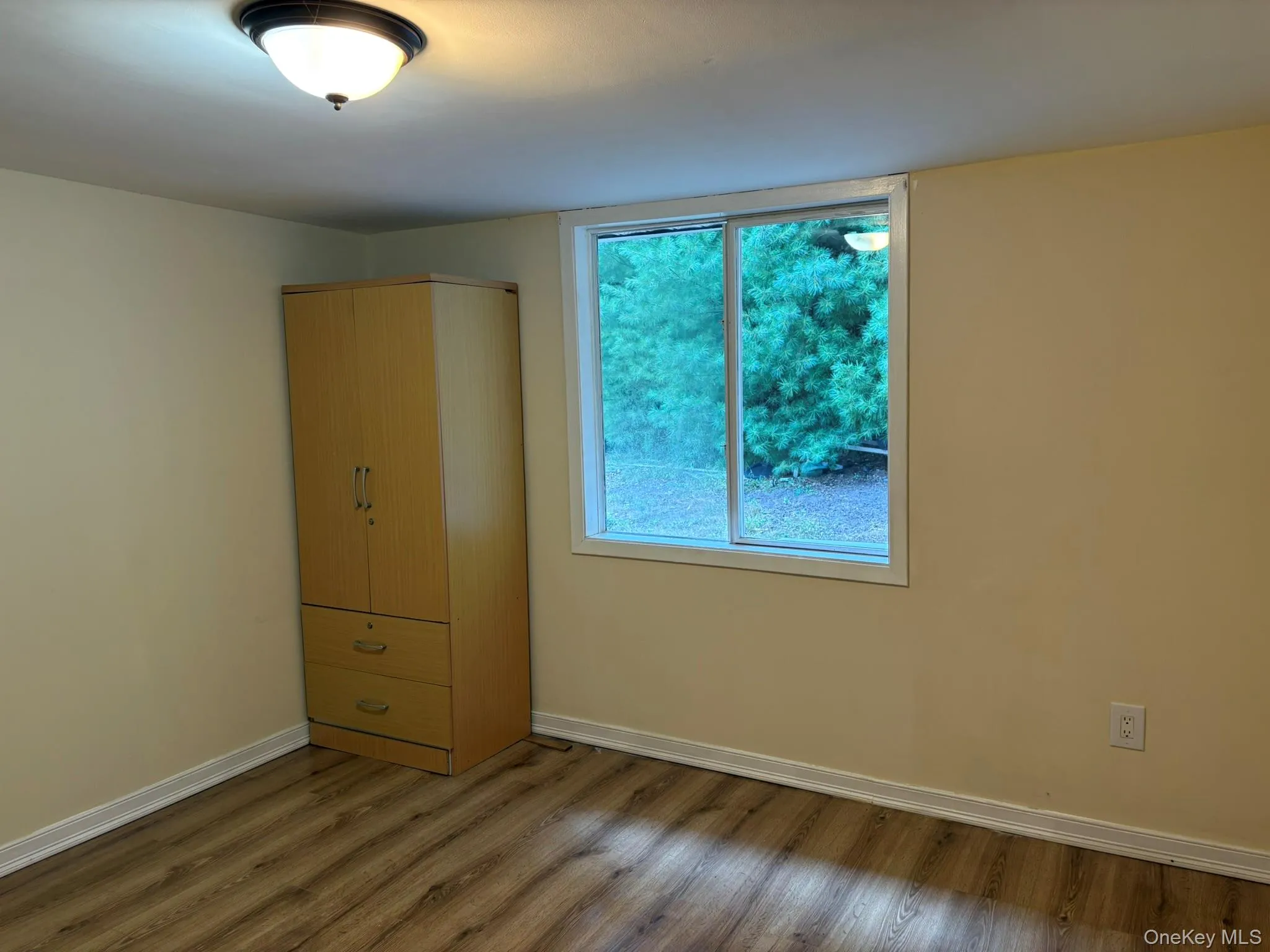 Unfurnished bedroom featuring wood finished floors and a closet Unfurnished bedroom featuring wood finished floors and a closet