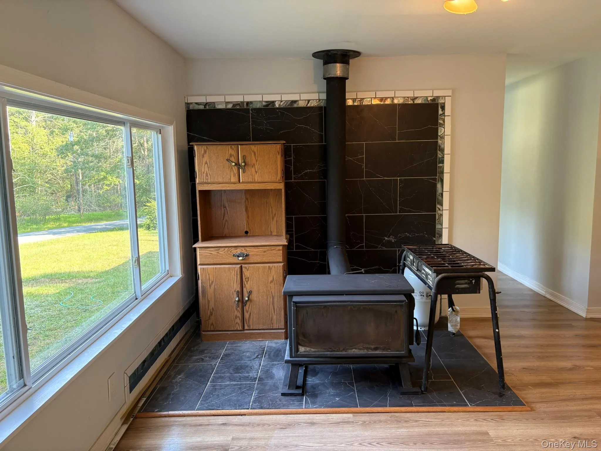Detailed view of a wood stove and wood finished floors Detailed view of a wood stove and wood finished floors