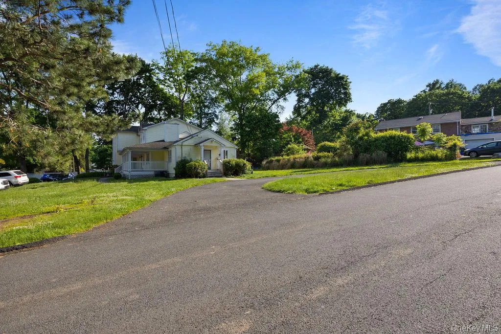 Bungalow-style house featuring a front yard and covered porch Bungalow-style house featuring a front yard and covered porch