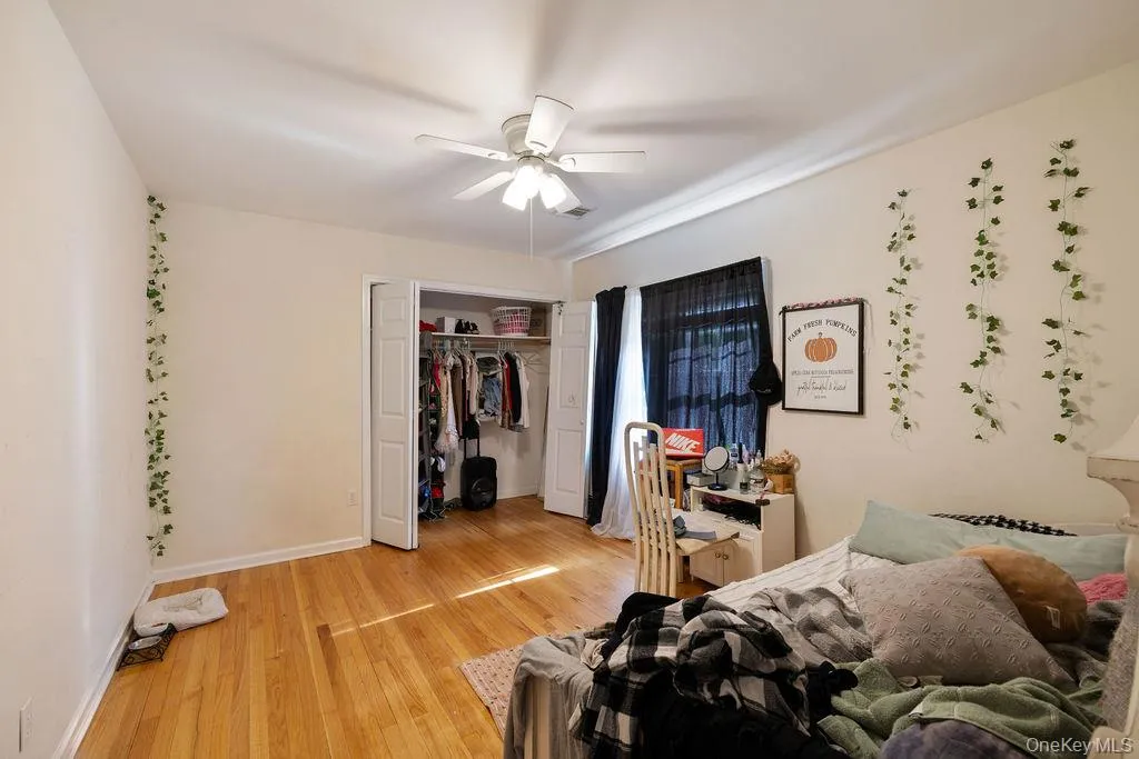 Bedroom featuring light wood-style flooring, a closet, and a ceiling fan Bedroom featuring light wood-style flooring, a closet, and a ceiling fan