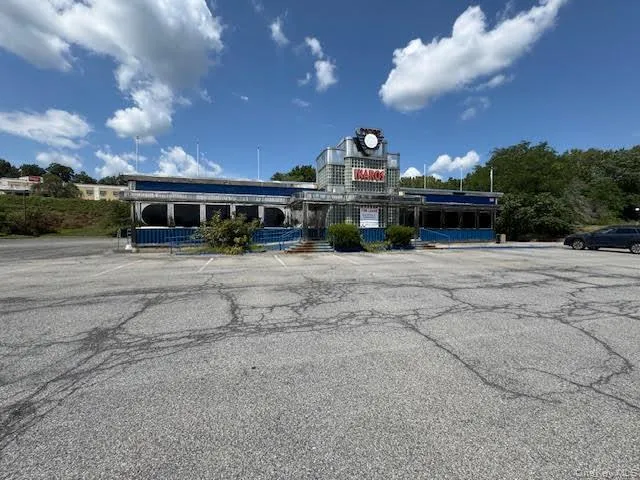 View of building exterior with uncovered parking View of building exterior with uncovered parking